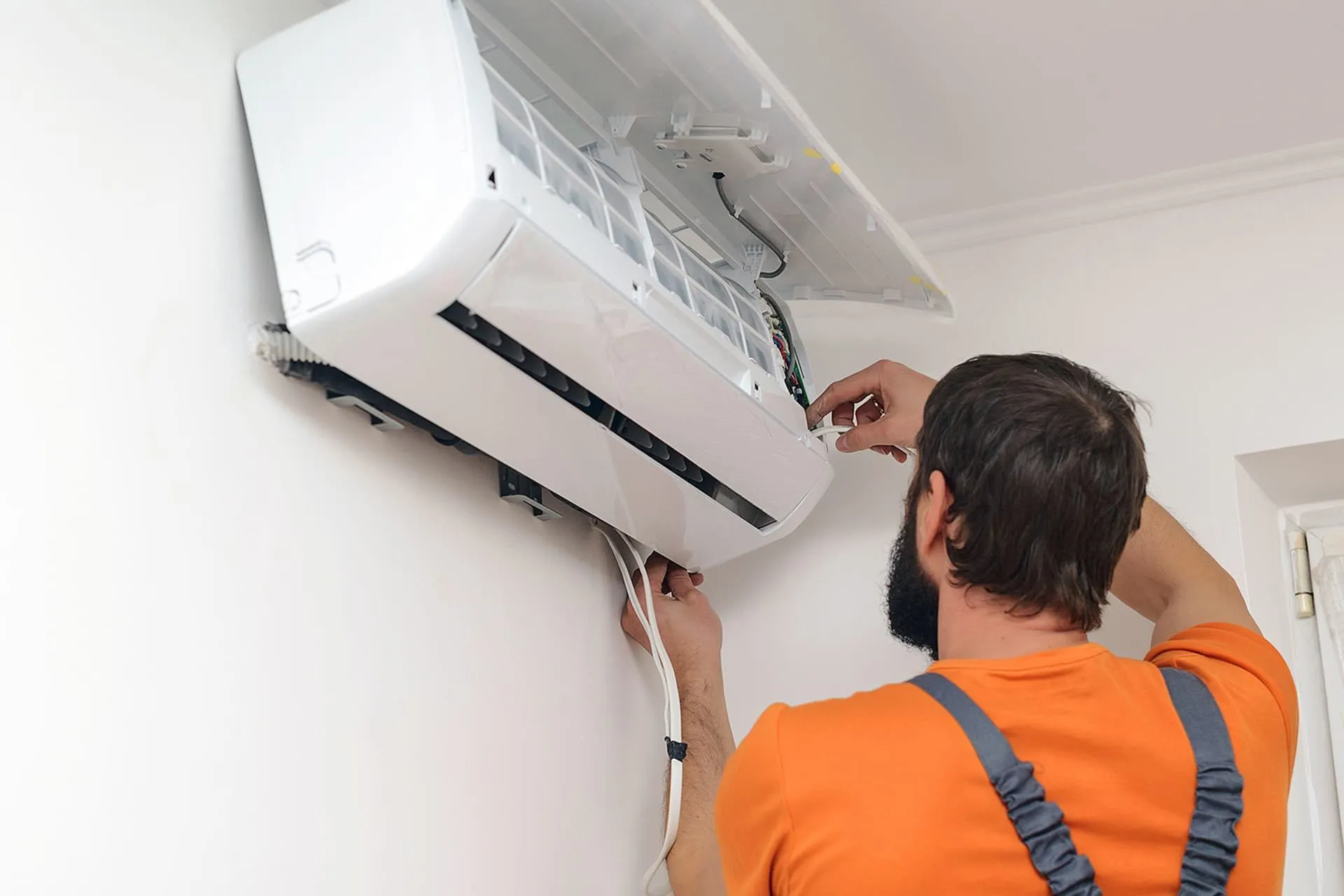 Broken air conditioner unit being diagnosed by expert