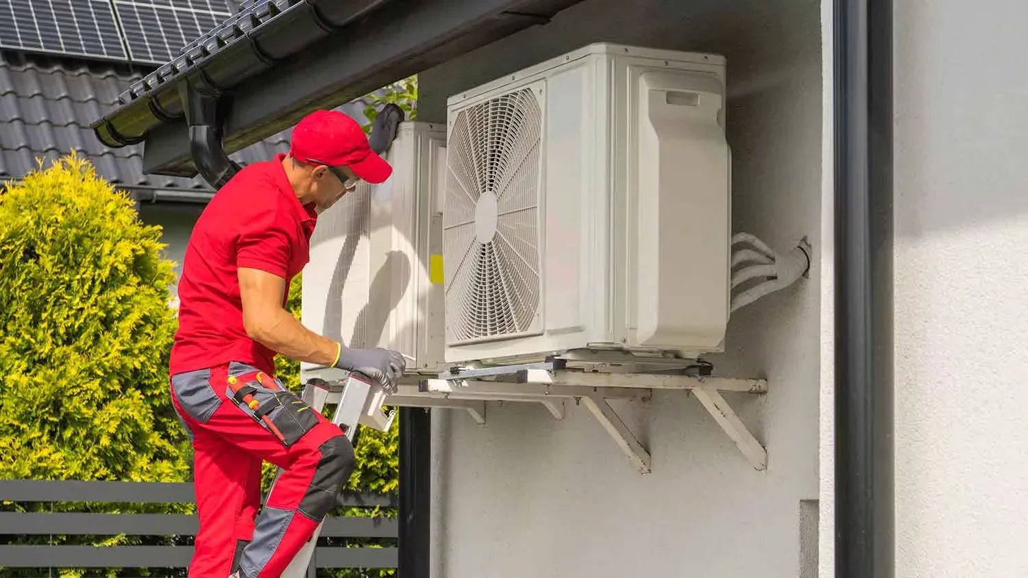 Emergency AC repair technician working in heat