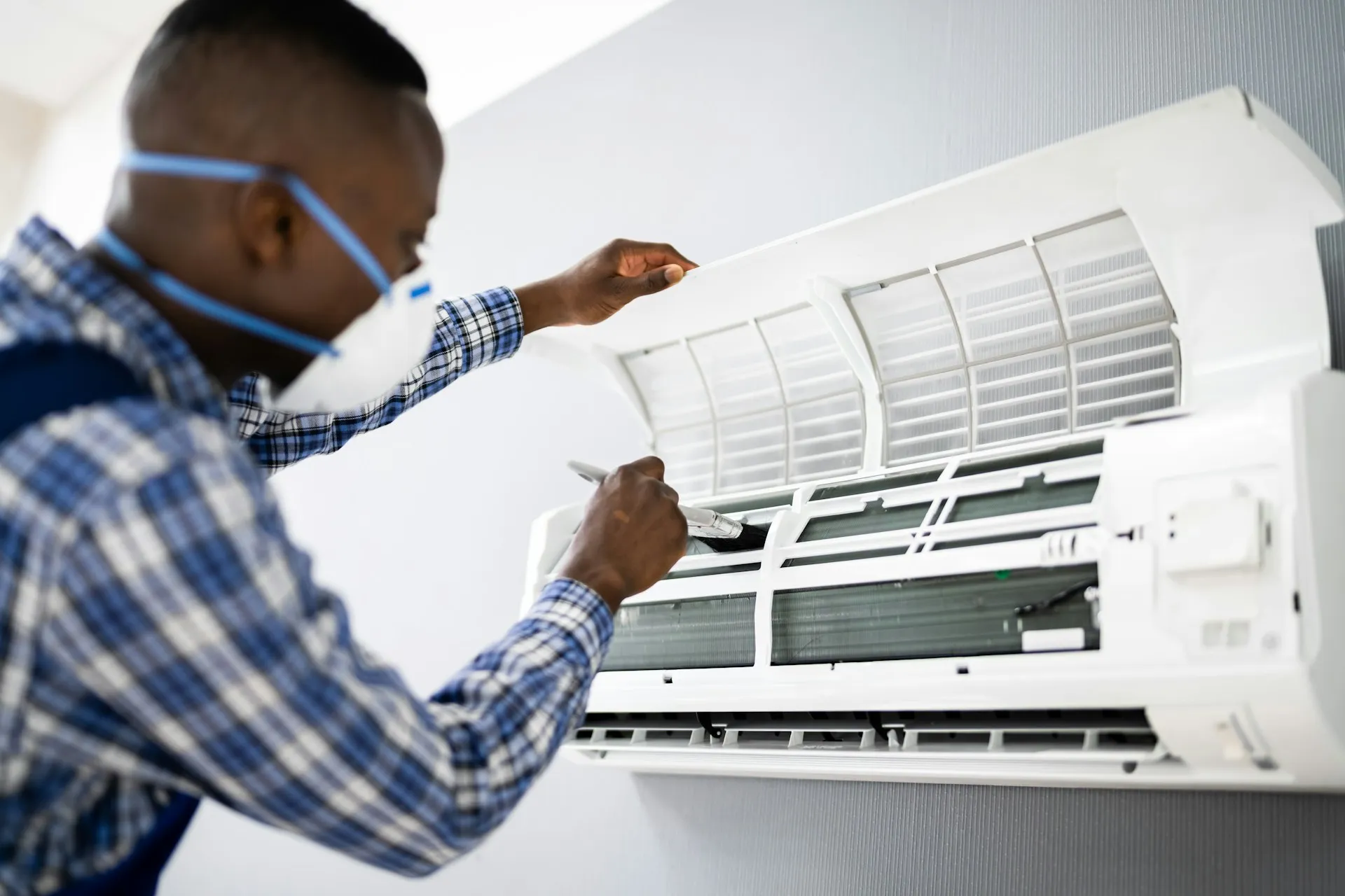 AC repair technician using diagnostic equipment on system