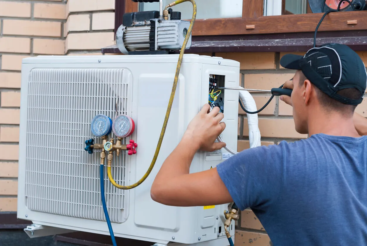 AC repair specialist installing new air conditioning unit